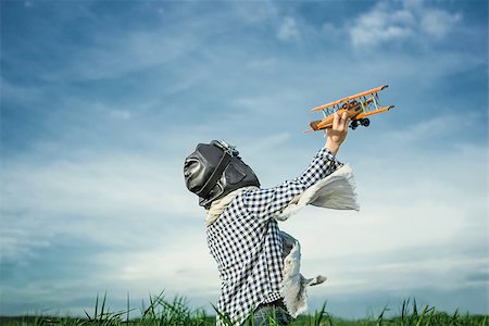 pilots with scarves - Boy with wooden airplane outdoors Stock Photo - Budget Royalty-Free & Subscription, Code: 400-08262198