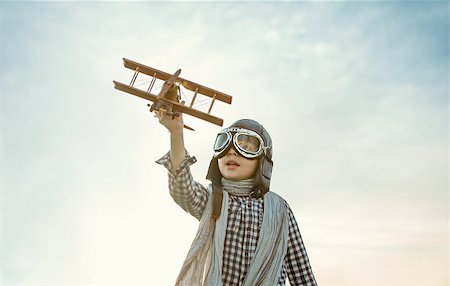 Little boy with wooden airplane outdoors Stock Photo - Budget Royalty-Free & Subscription, Code: 400-08263108