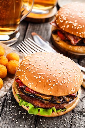 Delicious burgers with fried potato balls and beer on a rustic table Stock Photo - Budget Royalty-Free & Subscription, Code: 400-08284219