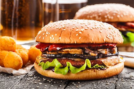 Delicious burgers with fried potato balls and beer on a rustic table Stock Photo - Budget Royalty-Free & Subscription, Code: 400-08284220