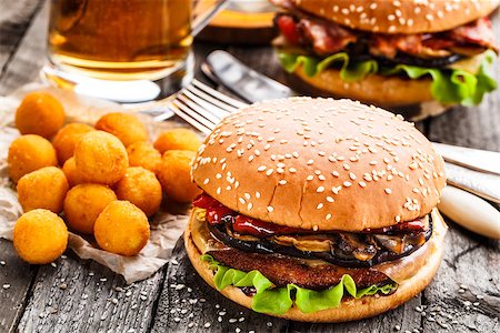 Delicious burgers with fried potato balls and beer on a rustic table Stock Photo - Budget Royalty-Free & Subscription, Code: 400-08284221