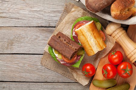 simsearch:400-07099478,k - Two sandwiches with salad, ham, cheese and tomatoes on wooden table with copy space Stock Photo - Budget Royalty-Free & Subscription, Code: 400-08284666