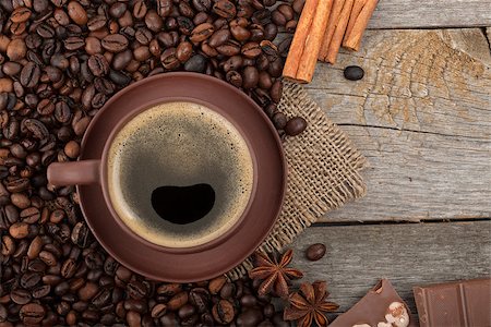 simsearch:400-07299272,k - Coffee cup, spices and chocolate on wooden table texture with copy space. View from above Fotografie stock - Microstock e Abbonamento, Codice: 400-08284700