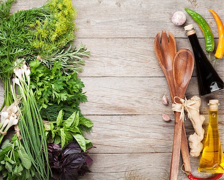 simsearch:400-07578178,k - Fresh garden herbs and condiments over wooden table. Top view with copy space Stock Photo - Budget Royalty-Free & Subscription, Code: 400-08284763