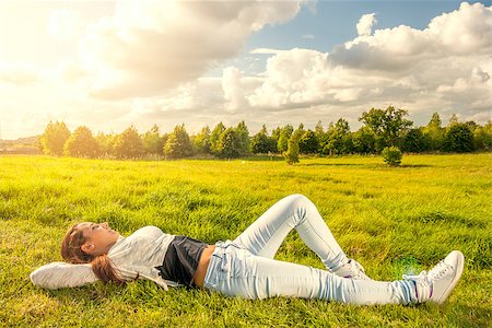 Beautiful teenager lying on the grass at the park Stock Photo - Budget Royalty-Free & Subscription, Code: 400-08285058