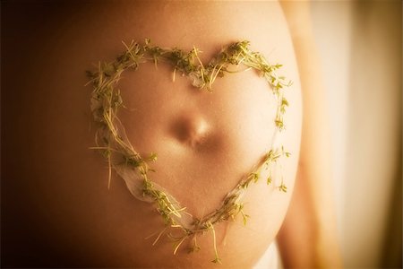 simsearch:400-08529613,k - Image of a baby bump with cream cress heart in warm sun light Stock Photo - Budget Royalty-Free & Subscription, Code: 400-08285829