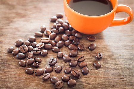 simsearch:400-05382322,k - Coffee beans with coffee cup on wooden table, stock photo Stockbilder - Microstock & Abonnement, Bildnummer: 400-08286264