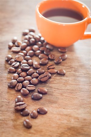 simsearch:400-05382322,k - Coffee beans with coffee cup on wooden table, stock photo Stockbilder - Microstock & Abonnement, Bildnummer: 400-08286265