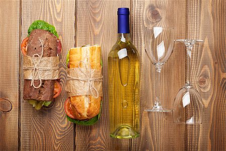 simsearch:400-07937807,k - Two sandwiches and white wine on wooden table. Top view Photographie de stock - Aubaine LD & Abonnement, Code: 400-08286444