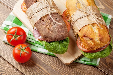 simsearch:400-07099478,k - Two sandwiches with salad, ham, cheese and tomatoes on wooden table Stock Photo - Budget Royalty-Free & Subscription, Code: 400-08286441