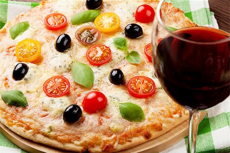 simsearch:400-08960199,k - Italian pizza with cheese, tomatoes, olives, basil and red wine on wooden table Stock Photo - Budget Royalty-Free & Subscription, Code: 400-08286455