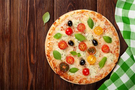 simsearch:400-08291219,k - Italian pizza with cheese, tomatoes, olives and basil on wooden table. Top view with copy space Stock Photo - Budget Royalty-Free & Subscription, Code: 400-08286451