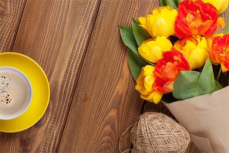 simsearch:400-08036453,k - Colorful tulips bouquet and coffee cup on wooden table. Top view with copy space Stock Photo - Budget Royalty-Free & Subscription, Code: 400-08286494