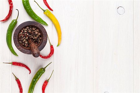 simsearch:400-04846756,k - Colorful chili peppers and peppercorn on white wooden table. Top view with copy space Stock Photo - Budget Royalty-Free & Subscription, Code: 400-08286522