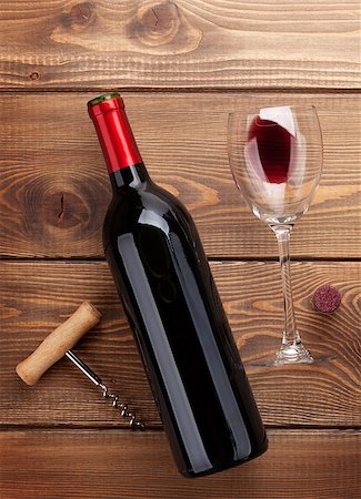 simsearch:400-07937813,k - Red wine bottle, glass and corkscrew on wooden table background. Top view Photographie de stock - Aubaine LD & Abonnement, Code: 400-08286622