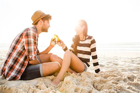 sunset drinking beer - Young couple at the beach having fun, laughing and drinking beer Stock Photo - Budget Royalty-Free & Subscription, Code: 400-08287046