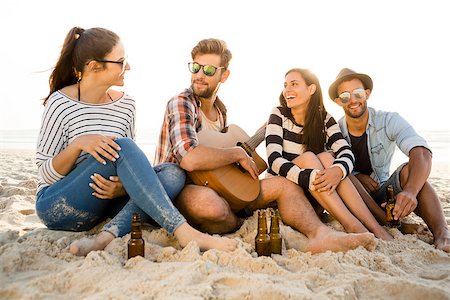 sunset drinking beer - Friends having fun together at the beach, playing guitar and drinking beer Stock Photo - Budget Royalty-Free & Subscription, Code: 400-08287050