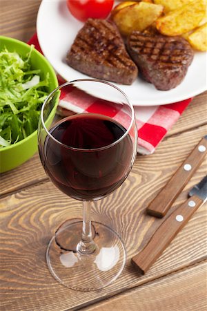simsearch:640-02952163,k - Glass of red wine and steak with salad on wooden table Stock Photo - Budget Royalty-Free & Subscription, Code: 400-08287244