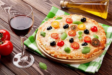 simsearch:400-03992643,k - Italian pizza with cheese, tomatoes, olives, basil and red wine on wooden table Stock Photo - Budget Royalty-Free & Subscription, Code: 400-08287254