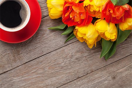 simsearch:400-08036453,k - Colorful tulips bouquet and coffee cup on wooden table. Top view with copy space Stock Photo - Budget Royalty-Free & Subscription, Code: 400-08287270