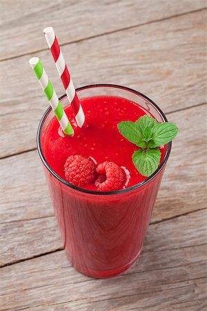 Raspberry smoothie and berries on wooden table Stock Photo - Budget Royalty-Free & Subscription, Code: 400-08287326