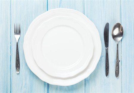 Empty plate and silverware over wooden table background. View from above with copy space Stock Photo - Budget Royalty-Free & Subscription, Code: 400-08287366