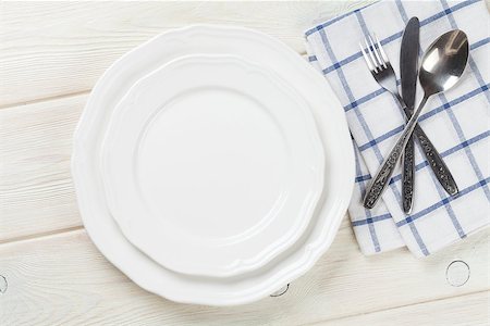 restaurant in blue with table setting - Empty plate and silverware over wooden table background. View from above with copy space Stock Photo - Budget Royalty-Free & Subscription, Code: 400-08287368