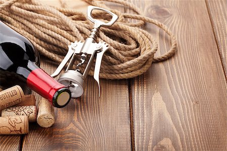 simsearch:400-07933837,k - Red wine bottle, corks and corkscrew over wooden table background with copy space Stockbilder - Microstock & Abonnement, Bildnummer: 400-08287451