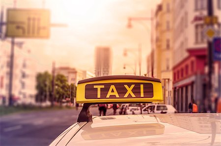 Taxi sign on top of a german cab in the evening sun, intentional selective focus Stock Photo - Budget Royalty-Free & Subscription, Code: 400-08287578