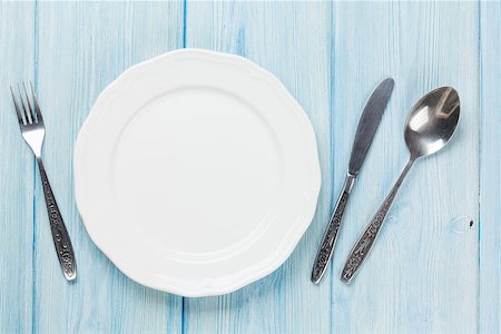 Empty plate and silverware over wooden table background. View from above with copy space Stock Photo - Budget Royalty-Free & Subscription, Code: 400-08288575