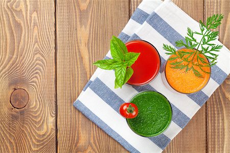 simsearch:400-07172598,k - Fresh vegetable smoothie on wooden table. Tomato, cucumber, carrot. Top view with copy space Stock Photo - Budget Royalty-Free & Subscription, Code: 400-08288592