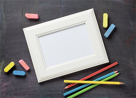 Photo frame and school supplies on blackboard background. Top view with copy space Stock Photo - Budget Royalty-Free & Subscription, Code: 400-08288622