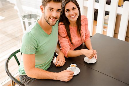 Youg couple at the local coffee shop drinking a coffee Stock Photo - Budget Royalty-Free & Subscription, Code: 400-08289232