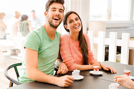 Youg couple at the local coffee shop drinking a coffee Stock Photo - Budget Royalty-Free & Subscription, Code: 400-08289233