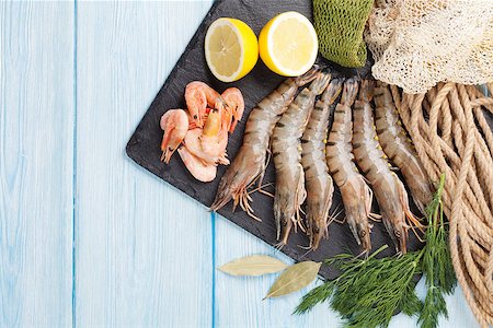 shrimp fishing - Fresh raw tiger prawns and fishing equipment on wooden table. Top view with copy space Stock Photo - Budget Royalty-Free & Subscription, Code: 400-08289453