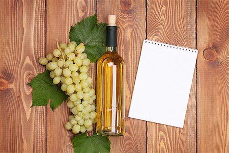 simsearch:400-08110621,k - White wine bottle and bunch of white grapes on wooden table background with notepad for copy space Stock Photo - Budget Royalty-Free & Subscription, Code: 400-08289472