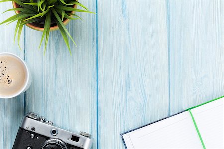 Office desk table with notepad, camera, coffee and flower. Top view with copy space Stock Photo - Budget Royalty-Free & Subscription, Code: 400-08289506