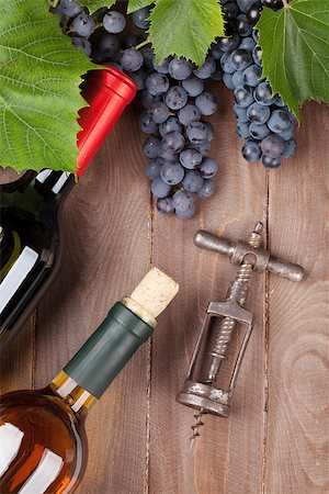 simsearch:400-08110621,k - Red grape, wine bottles and corkscrew on wooden table. Top view Stock Photo - Budget Royalty-Free & Subscription, Code: 400-08289625
