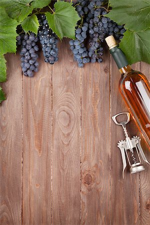 Red grape, wine bottle and corkscrew on wooden table. Top view with copy space Stock Photo - Budget Royalty-Free & Subscription, Code: 400-08289627