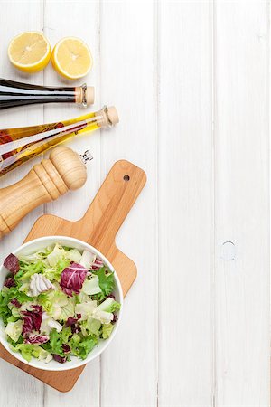 simsearch:400-06485512,k - Fresh healthy salad and condiments over white wooden table. View from above with copy space Stock Photo - Budget Royalty-Free & Subscription, Code: 400-08289638