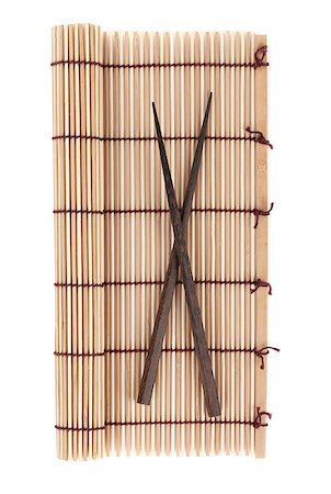 simsearch:400-07719212,k - Chopsticks over bamboo mat. Isolated on white background Fotografie stock - Microstock e Abbonamento, Codice: 400-08289642