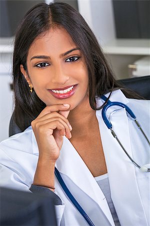 An Indian Asian female medical doctor in a hospital office happy and smiling with stethoscope Stock Photo - Budget Royalty-Free & Subscription, Code: 400-08289716