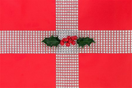 red ribbon and plant - Christmas diamond bling and holly gift wrapping over red paper background. Stock Photo - Budget Royalty-Free & Subscription, Code: 400-08282454