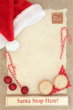 Christmas letter to santa claus with stop here sign on parchment paper with mince pies and decorations over brown paper background. Stock Photo - Budget Royalty-Free & Subscription, Code: 400-08282497