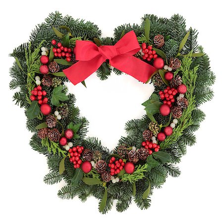 red ribbon and plant - Christmas heart shaped wreath with red bauble decorations and bow, holly, mistletoe, ivy and winter greenery over white background. Stock Photo - Budget Royalty-Free & Subscription, Code: 400-08282531