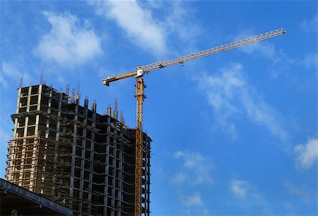 High-rise modern building under construction and crane against a blue cloudy sky Stock Photo - Budget Royalty-Free & Subscription, Code: 400-08282845