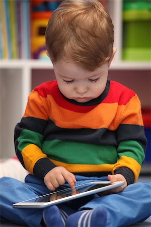 Happy 2 years old boy using a digital tablet computer Stock Photo - Budget Royalty-Free & Subscription, Code: 400-08283539