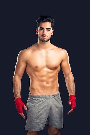 simsearch:400-04922500,k - Portrait of a young male Body Combat atlhlete, isolated over a dark background Photographie de stock - Aubaine LD & Abonnement, Code: 400-08294365