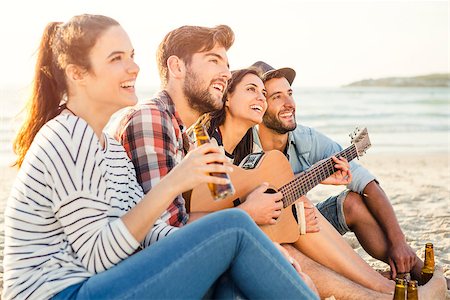 sunset hang out - Friends having fun together at the beach, playing guitar and drinking beer Foto de stock - Super Valor sin royalties y Suscripción, Código: 400-08294407