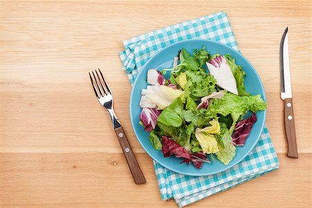 simsearch:400-06485512,k - Plate with fresh salad, knife and fork. Diet food on wooden table with copy space Stock Photo - Budget Royalty-Free & Subscription, Code: 400-08294928